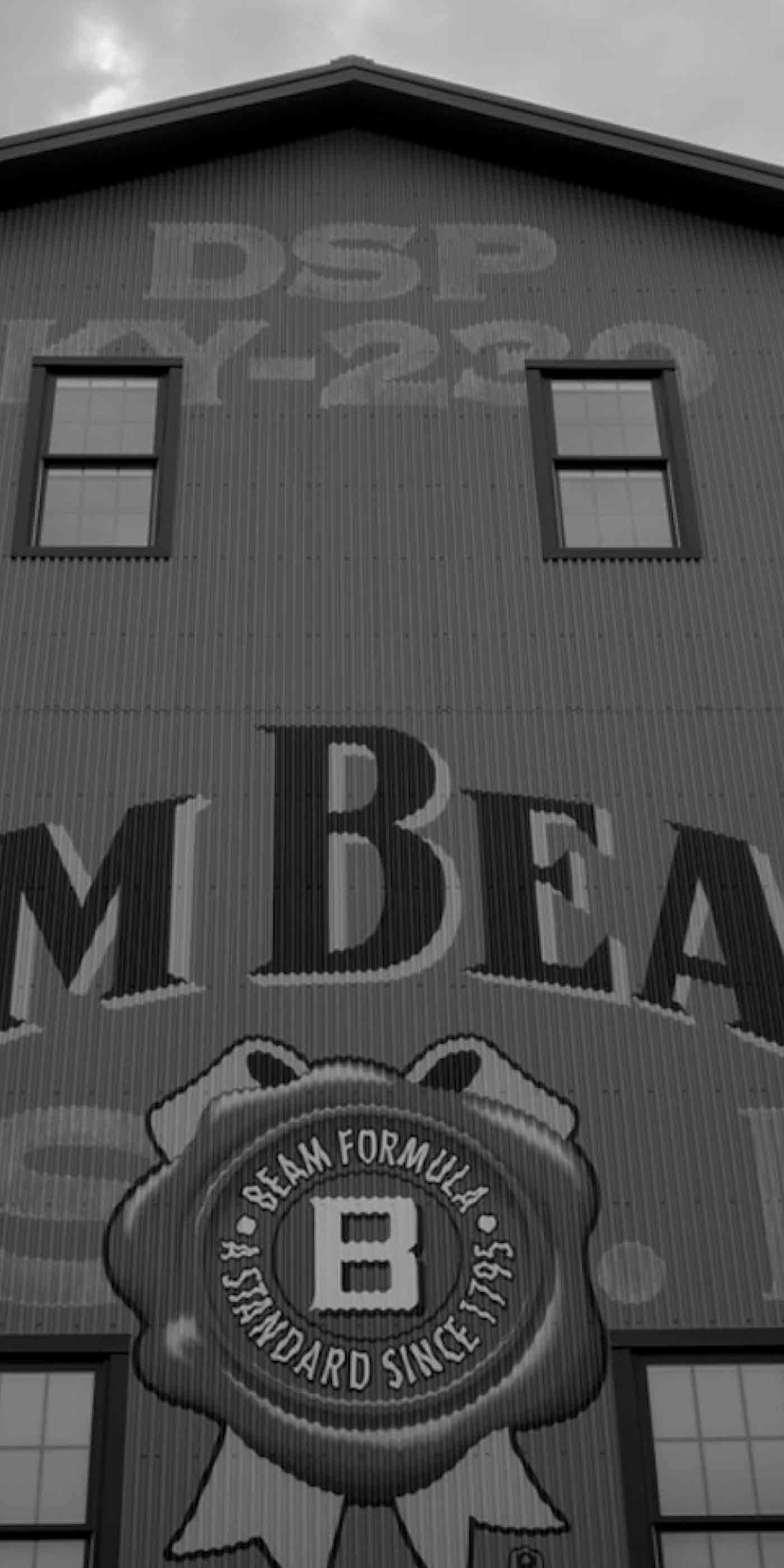 Black and white corrugated distillery building with large 'JIM BEAM' lettering—Make History movement modernizing a bourbon icon for a new generation