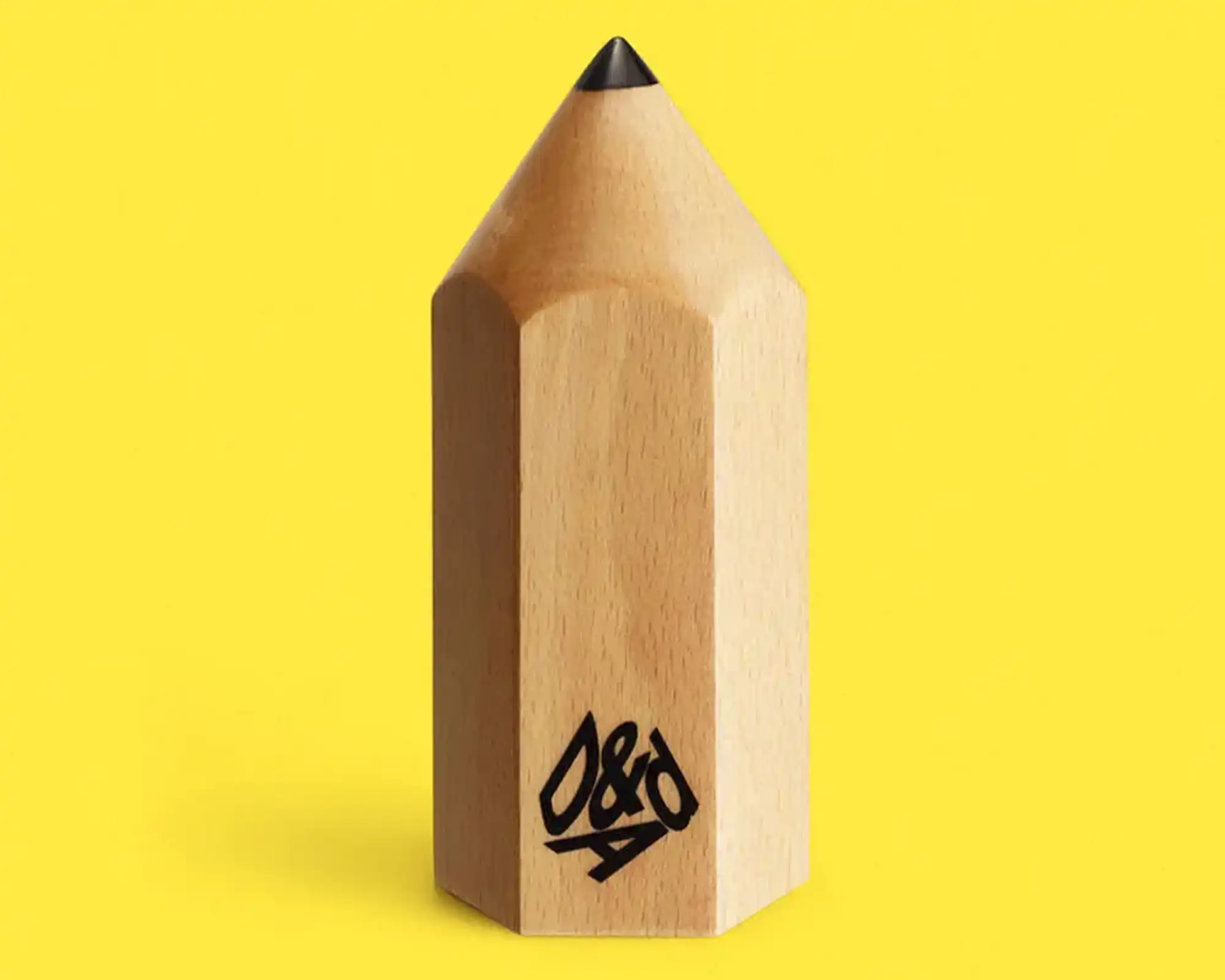 D&AD wooden pencil award trophy on yellow background - symbol of creative excellence in design and advertising