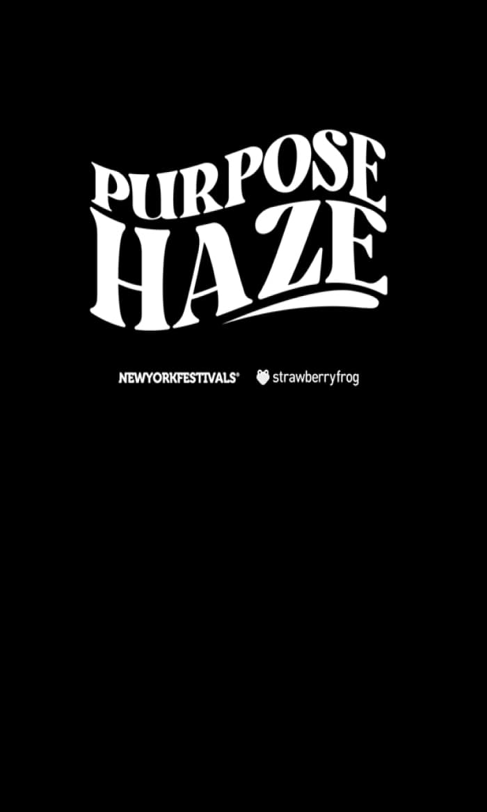 Black banner with white "PURPOSE HAZE" text in stylized arched letters, with "NEW YORK FESTIVALS" and "strawberryfrog" text below, featuring a small heart icon.